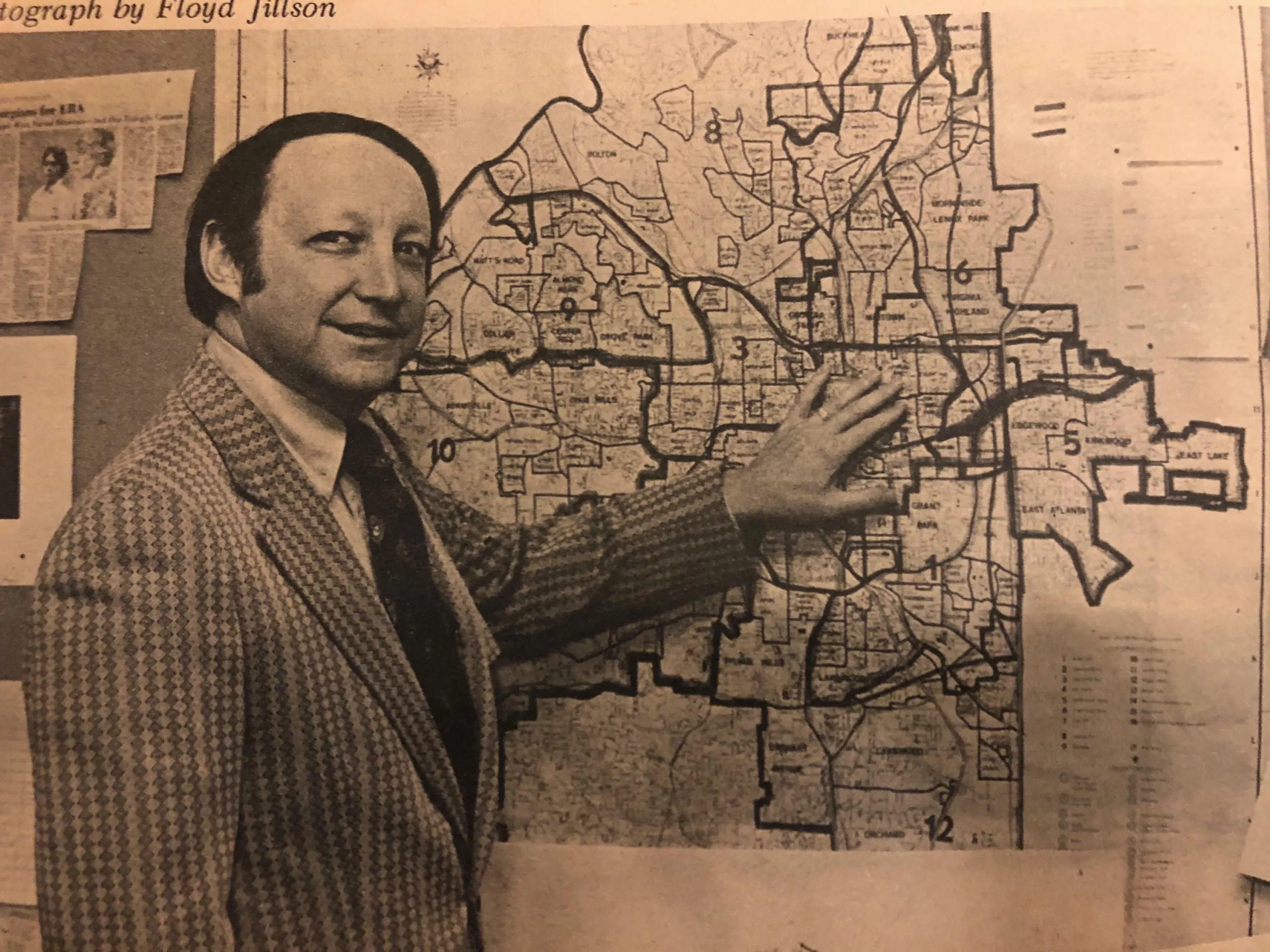 A white man standing beside a map of Atlanta